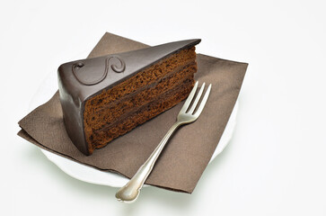 Piece of Sacher torte on white Plate