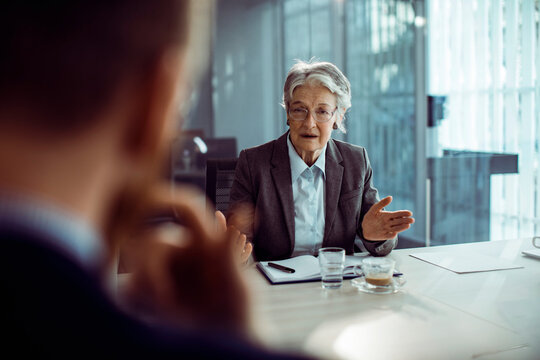 Senior woman in business meeting with diverse colleagues