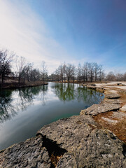 Low angle view of a calm lake in Forest Park in St. Louis on a sunny winter day