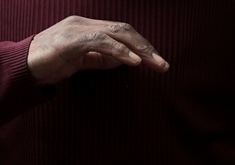 man praying to god with hands together Caribbean man praying on black background with people stock...