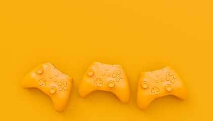 Video game joysticks or gamepads in plain monochrome yellow color background © Vasyl Onyskiv