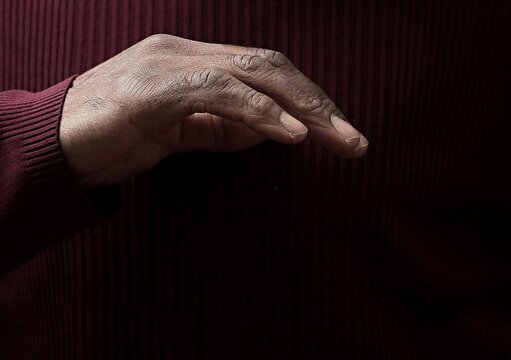 man praying to god with hands together Caribbean man praying on black background with people stock photos stock photo stock image