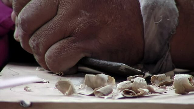 A Violin Maker Working with A Chisel in His Workshop. Close Up. 4K Resolution.
