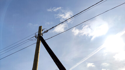Old pole with wires against the sky. Electric transmission line. Eco-friendly energy