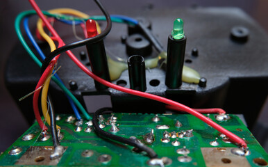 Cables, connections, solders, circuit elements inside an electronic device.