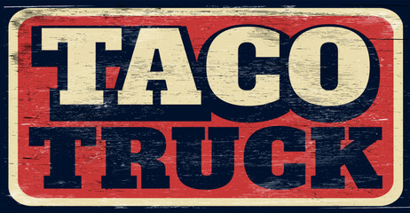 Aged and worn taco truck sign on wood