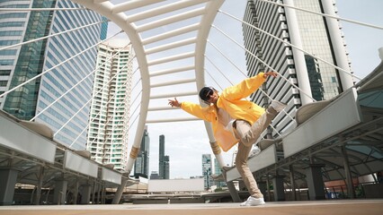 Stylish asian man perform hiphop dancing with low angle camera. Break dancer walking up the stair...