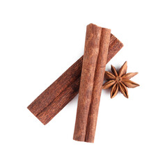 Cinnamon sticks and anise star isolated on white, top view