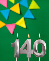 Vertical birthday card with number 140 candle - Green background with pennants