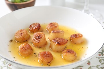 Delicious fried scallops with sauce on table, closeup