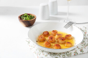 Delicious fried scallops served on white. Space for text