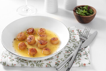 Delicious fried scallops served on white table