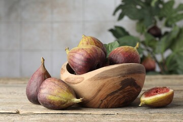 Many fresh ripe figs on wooden table