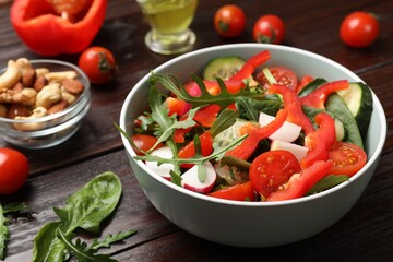Tasty fresh vegetarian salad on dark wooden table