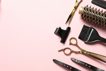 Professional hair dresser tools on pink background, flat lay. Space for text