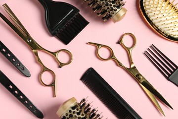 Professional hair dresser tools on pink background, flat lay