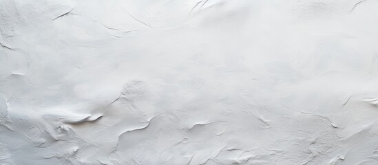 A close up of a white wall with a texture resembling snow or freezing wind patterns. The fluidity of the design evokes a sense of winter and cumulus clouds floating by
