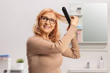 Woman using a hair straightener