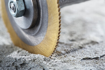 Metal saw, end mill or drill bit with diamond coating makes hole in concrete slab. Industry and construction.