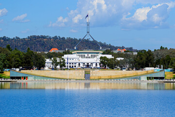 Fototapeta na wymiar Parliament House of Australia on Capital Hill, as seen from the Molonglo River in Canberra, Australian Capital Territory