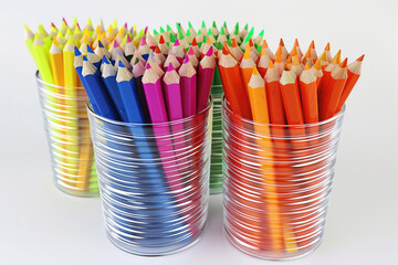 Colorful pencils in a cup, ideal for school or art projects
