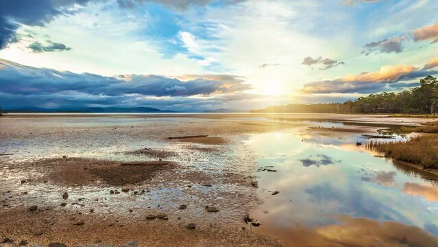 Daniels Bay at sunset, Lunawanna, Bruny Island, Tasmania, Australia. Clouds in the sky reflected on the water. Cinemagraph.