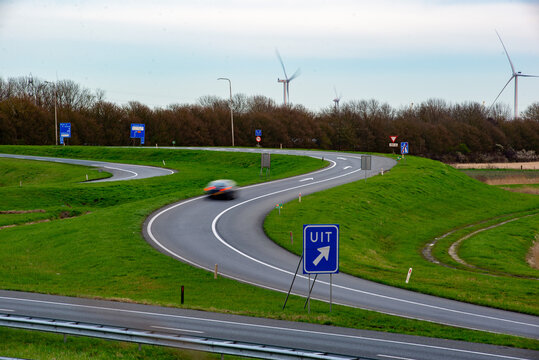 Exit 39 towards Middelburg Centre, highway A58, near Ritthem, Zeeland, The Netherlands. Wind turbines in background.
