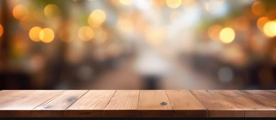 Gordijnen A hardwood plank table featuring a wood stain pattern, set against a blurry street background. Macro photography highlights the tints and shades of the lumber © TheWaterMeloonProjec