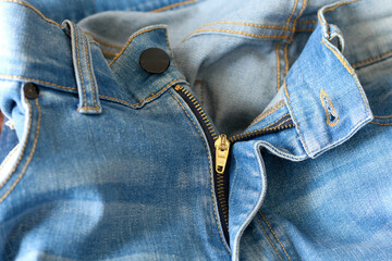 A detailed shot capturing the pocket and stitching details of a blue denim jeans