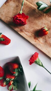 still life, bowl, strawberries, red flowers, arrangement, composition, visual, multimedia, footage, creative, content, camera angle, tabletop, floral display, interior design, lifestyle, aesthetic, el