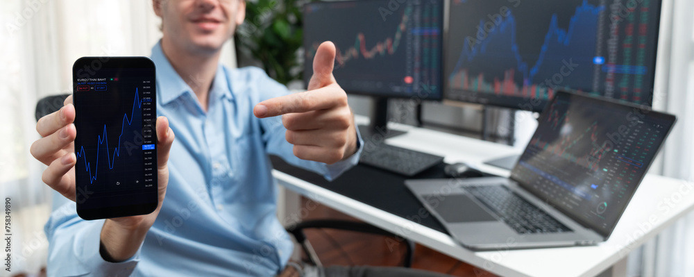 Poster successful young business trader showing dynamic stock market graph on smartphone, presenting infoma