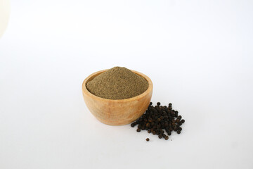 raw material pepper and powder in a wooden bowl