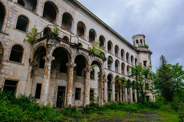 Fototapeta premium Ruined overgrown old abandoned Soviet sanatorium Iveria, Tskaltubo, Georgia