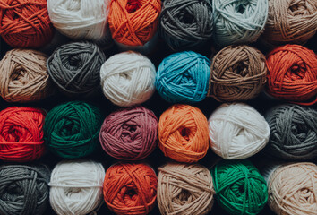 Rows of a selection of amigurumi cotton yarn, shallow focus. - obrazy, fototapety, plakaty