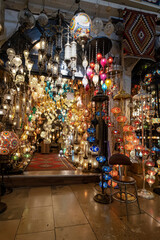 bright vivid lamps , chandeliers pendants lustres lampshades, window display of a street store of...