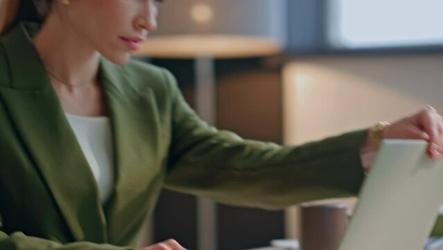 Closeup lady opening computer at office. Businesswoman started work at morning