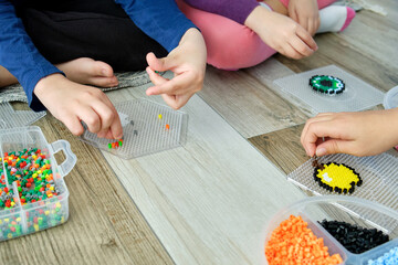 Anonymous children Engaged in Creative Play with Hama Beads