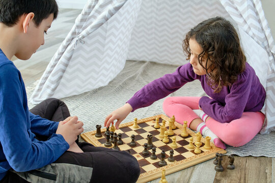 Children engaged in a focused game of chess