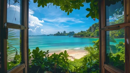 Photo sur Plexiglas Railay Beach, Krabi, Thaïlande View from the house from inside an open window to the beach with blue water, white sand beach, rocks in the background, turquoise sea water, tropical forest, sunny day. View from the window.