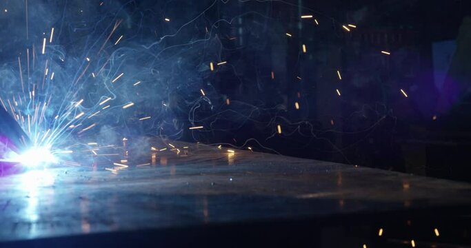 Arc welding close up in dark shop