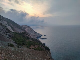 rocky coast under clody sky at cap de garde lighthouse at sunset in Annaba