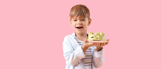 Cute little boy with Birthday cake on pink background