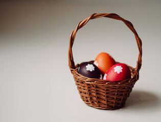 Easter basket with eggs on white background