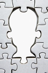 Silhouette of a person made up of puzzle pieces, but some pieces are missing