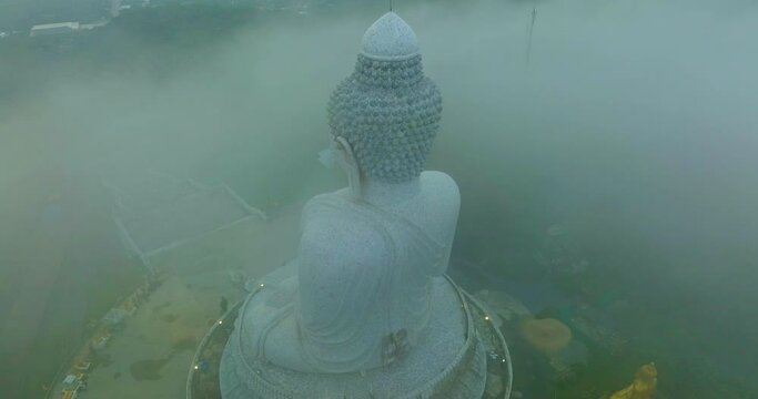 aerial view The Big Buddha of Phuket can only be seen as the head peeking out from the sea of mist..Phuket Big Buddha in the thick white mist. .A fluffy mist covers the Big Buddha in Phuket.