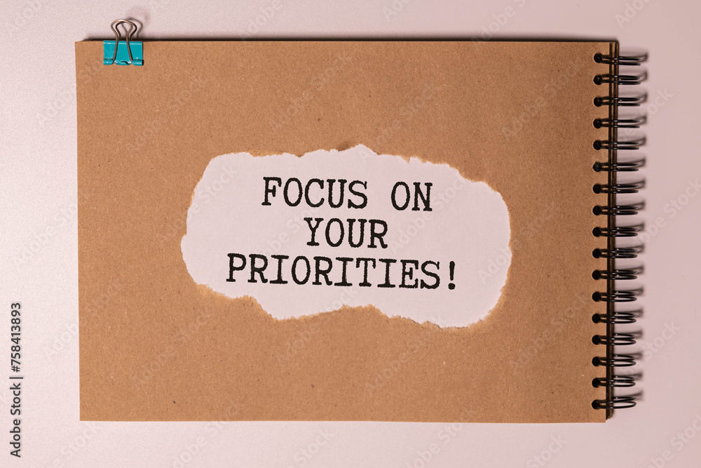 Poster focus on your priorities, text in notepad on keyboard from computer.
