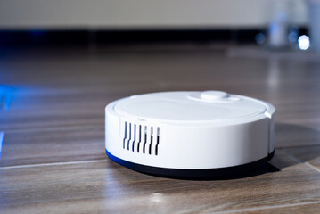 Robot vacuum cleaner in a modern living room on the floor. Smart vacuum cleaner in a smart home