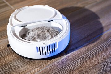 Robot vacuum cleaner in a modern living room on the floor. Smart vacuum cleaner in a smart home