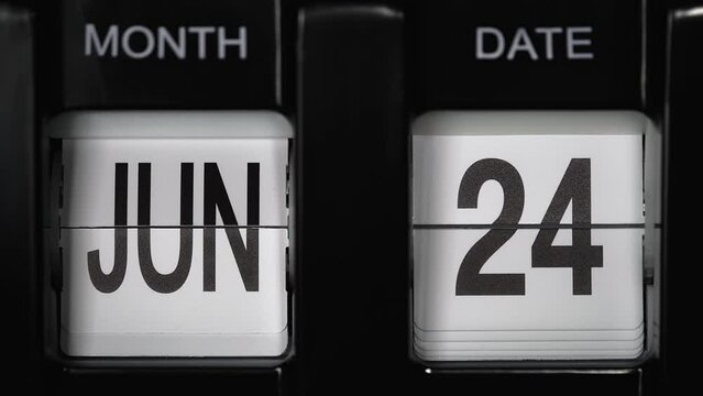 retro flip calendar with a date change from the twenty-third of June to the twenty-fourth of June. daily calendar with a change of days of the month. close up.