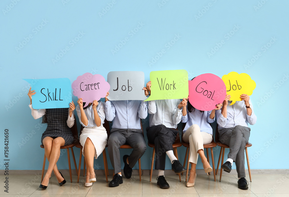 Wall mural business people holding speech bubbles with words near blue wall - Wall murals